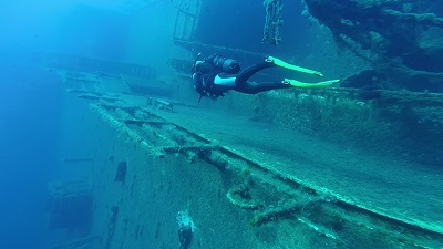scuba diver exploring the wreck of the zenobia